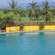 Mountains and palm trees surround a pool area